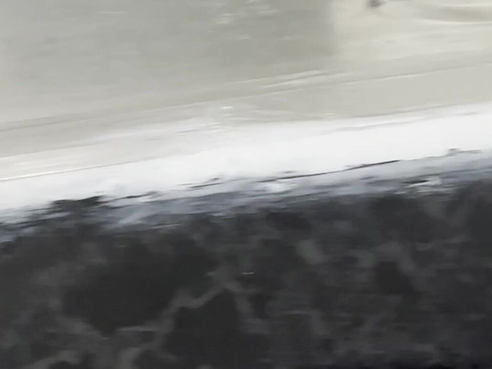 Sealant along the front of the sink, smeared over the worktop edge with a ragged, broken line